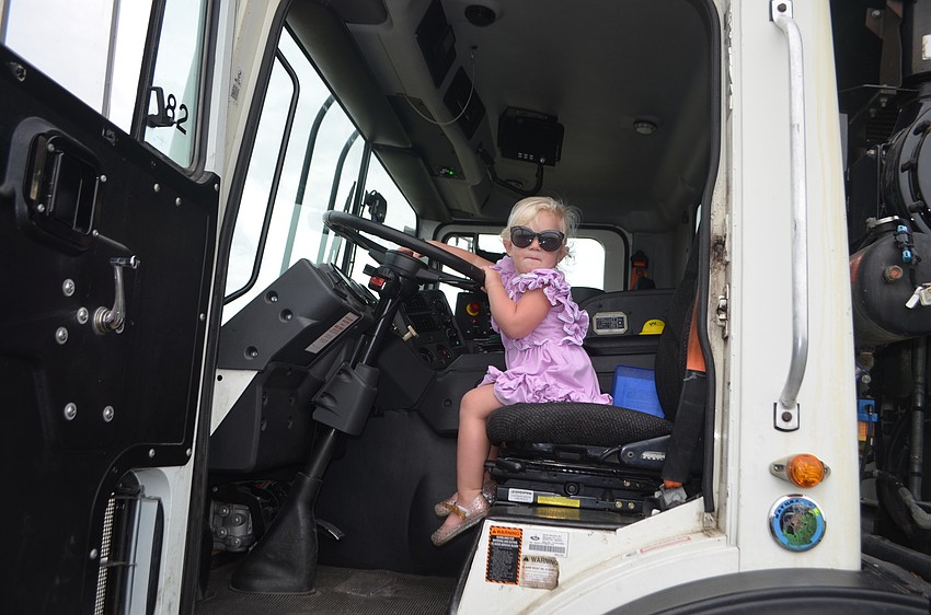 Lakewood Ranch's Sylvia McDonald, 2, plays around in the garbage truck.