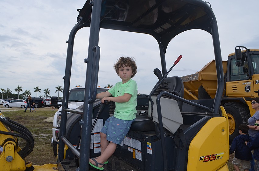 Parker Bookwalter, 3, from San Diego, shifts the gears around in the tractor.
