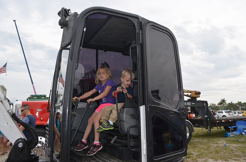 Sarasota's Sofia, 6, and Eli Bradley, 2, pretend to move crane around.