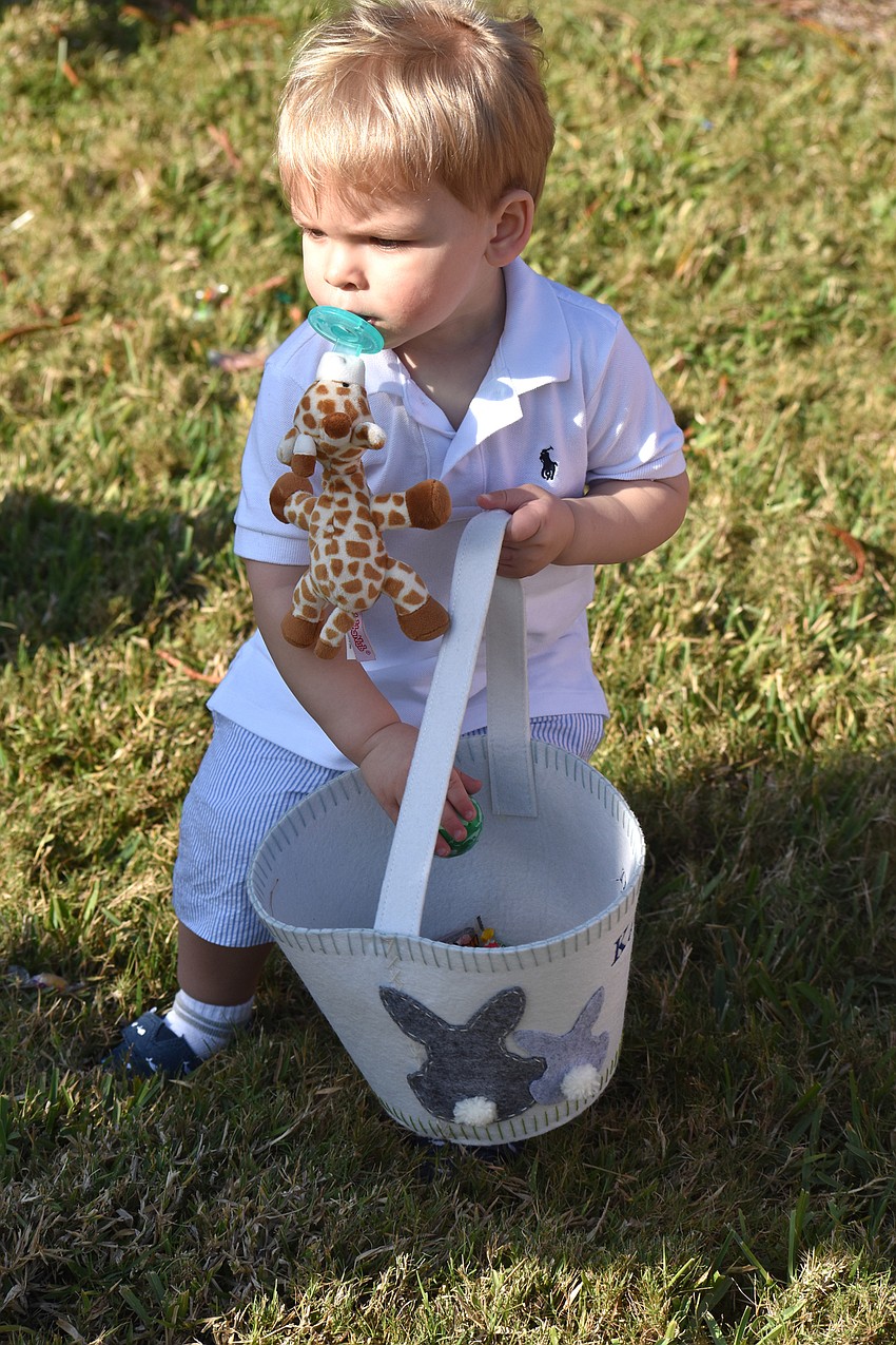 Kaion Fetherston fills his basket with eggs.