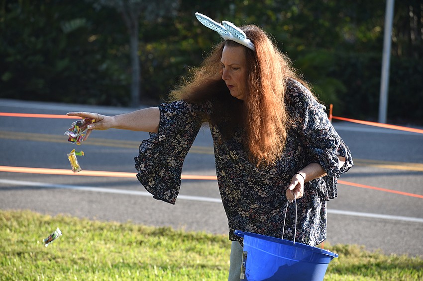 Cindy Philipp scatters candy on Casa Del Mar’s lawn.