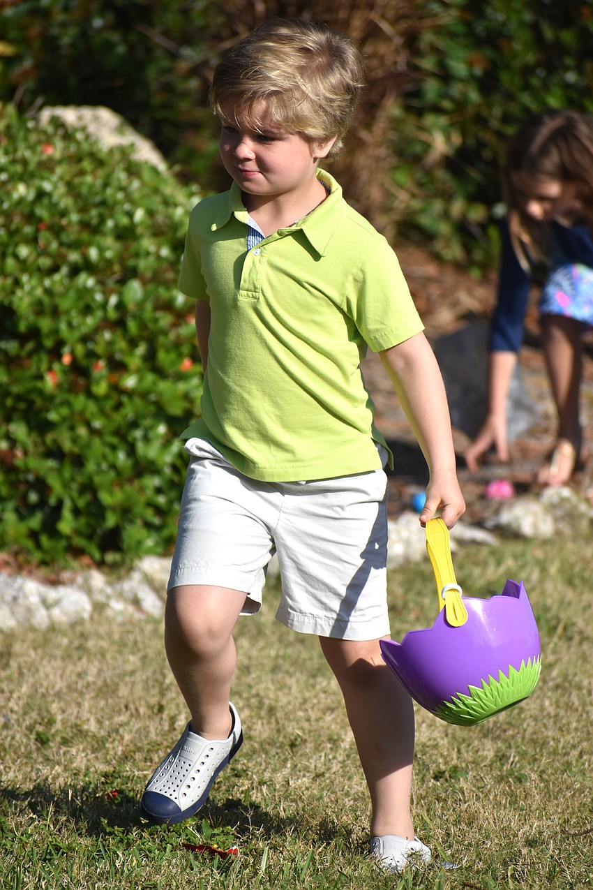 Teddy Buresh searches Casa Del Mar’s lawn for eggs and candy.