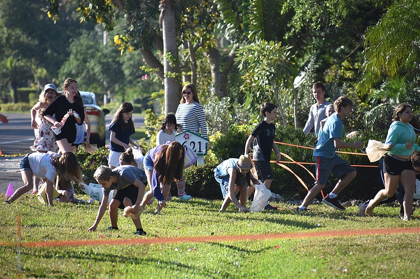 The older age group sprints around Casa Del Mar’s lawn looking for Easter eggs and candy.