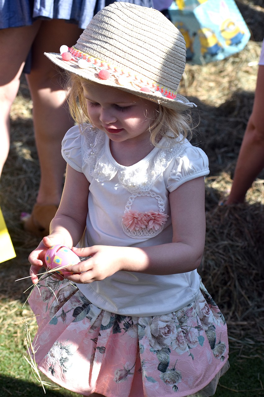 Paige Westlake checks out an egg she found during the Easter egg hunt.