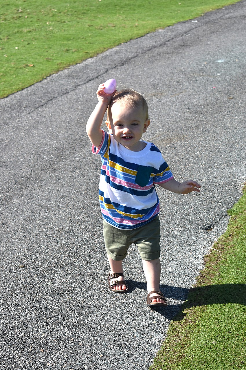 Lachlen Herold runs with an egg he found.
