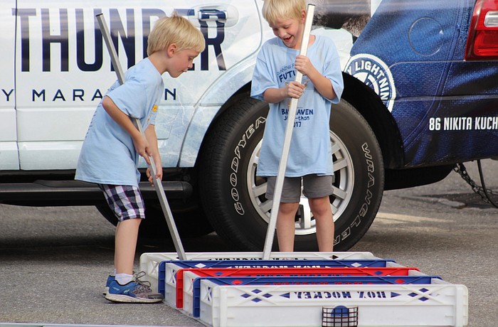 Sarasota's River and Alex Ross play with hockey sticks at the Watch Party last year.