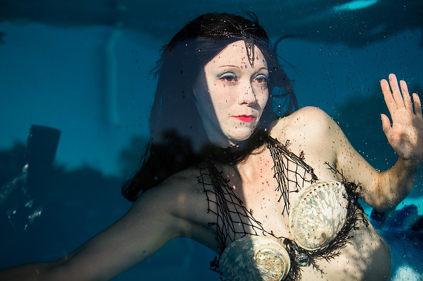 The mermaid posed for guests in the tank.