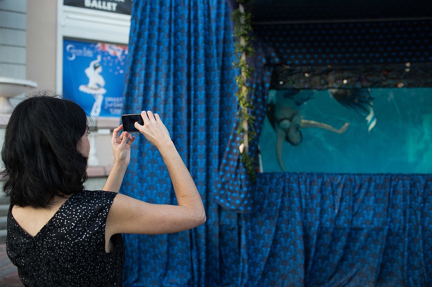 Hermione Gilpin takes a photo of the mermaid.