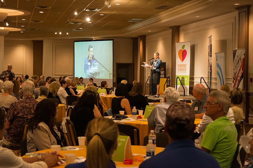 All Faiths Food Bank Board Chair Nelle Miller greets the crowd.