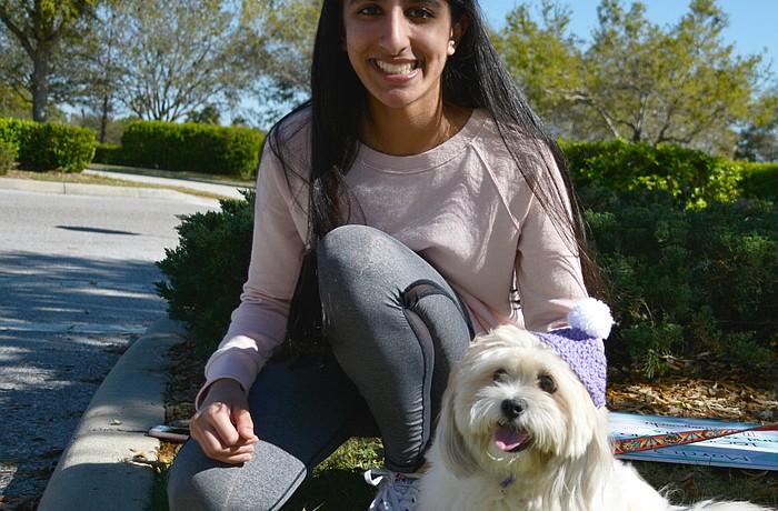 Mira Khazanchi shows off a Barkin Beanie hat modeled by her dog, Flossy. Courtesy photo.