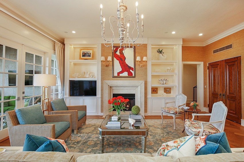 The casual living room features French doors, a custom coral gas fireplace and French oak floors.