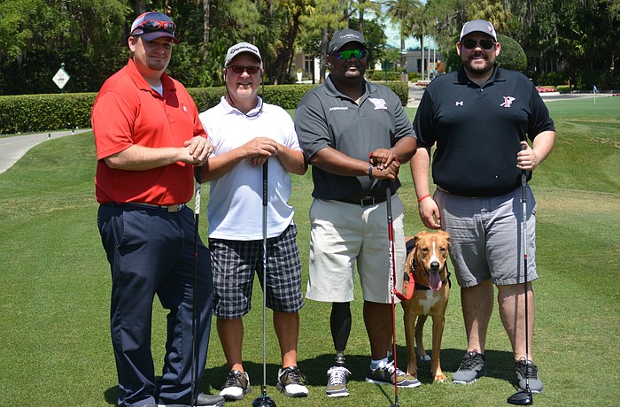 Lakewood Ranch's Kevin Conway, Sarasota's Dean Anderson, tournament honoree Christopher Gordon, service dog Blaze and Heritage Harbor's Nick Gyeszat go off the first tee at the fifth annual Rosedale Golf Classic April 4.