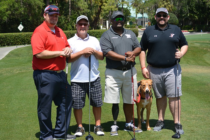 Lakewood Ranch's Kevin Conway, Sarasota's Dean Anderson, tournament honoree Christopher Gordon, service dog Blaze and Heritage Harbor's Nick Gyeszat go off the first tee at the fifth annual Rosedale Golf Classic April 4.