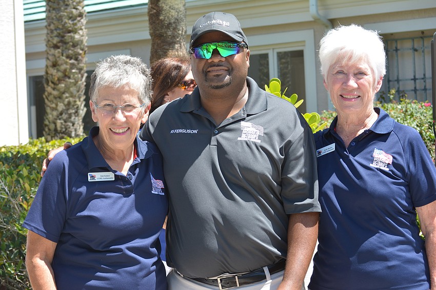 Tournament organizers Deb Kehoe and Kathi Skelton flank Staff Sgt. Christopher Gordon, who was being honored by the tournament.