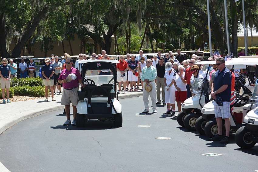 The Rosedale Golf Classic tournament field pauses for the National Anthem.