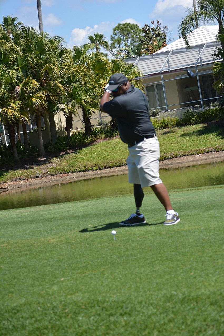 Christopher Gordon tees off on the first hole. He says being a Homes for Our Troops recipient and being honored by the tournament is 