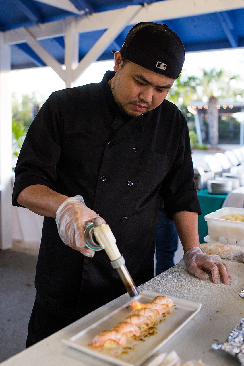 Nick Yu from Tsunami Sushi & Hibachi prepares a dish.