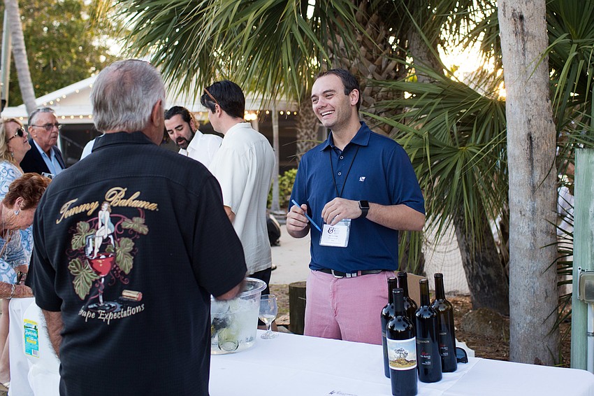 Sam Williamson talks to a guest about his wine.