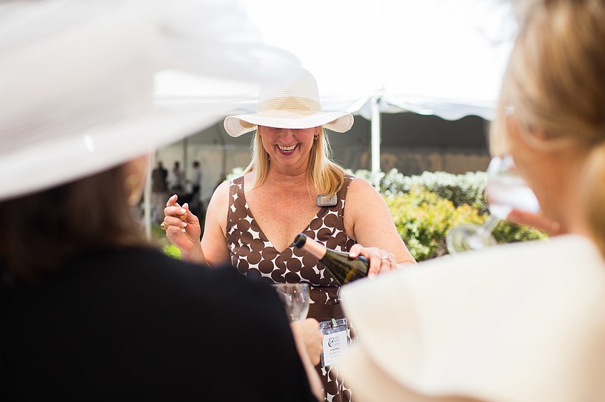Christine McMillan serves guests wine.