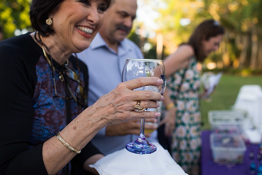 Wendy Ross smiles after getting her cup back with a newly painted bottom.
