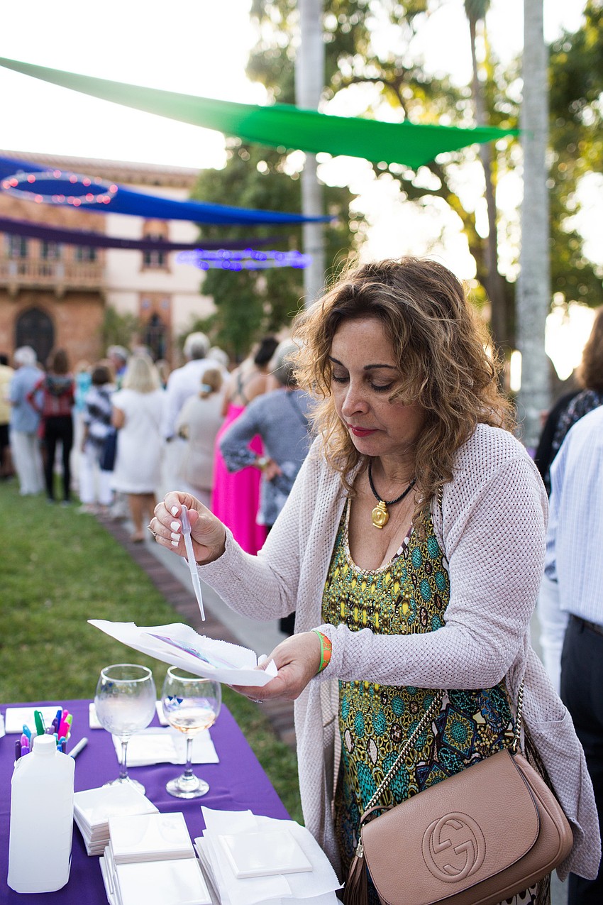 Rola Cotran drops alcohol on her tile.