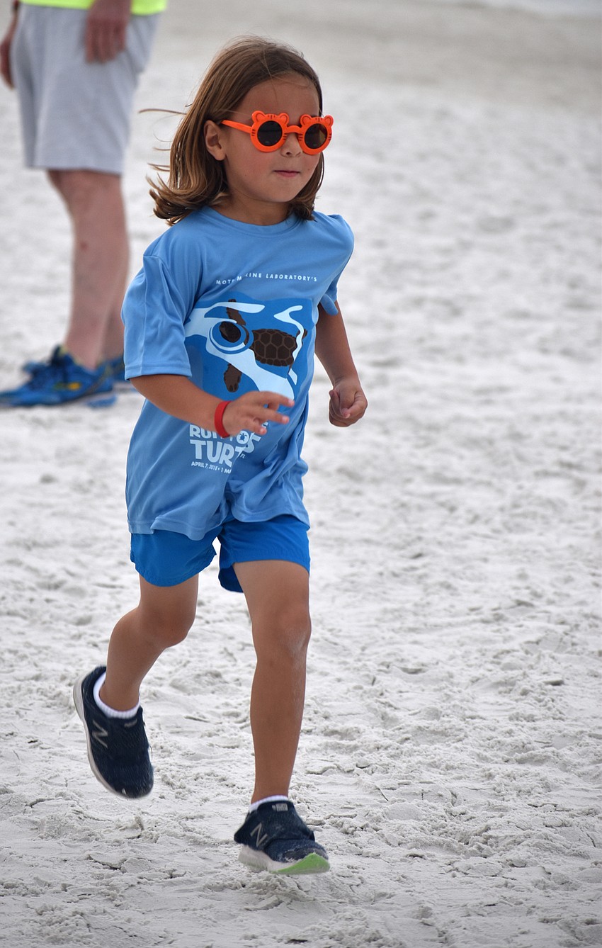 Riley Jimenez finishes the 1-mile fun-run/walk.