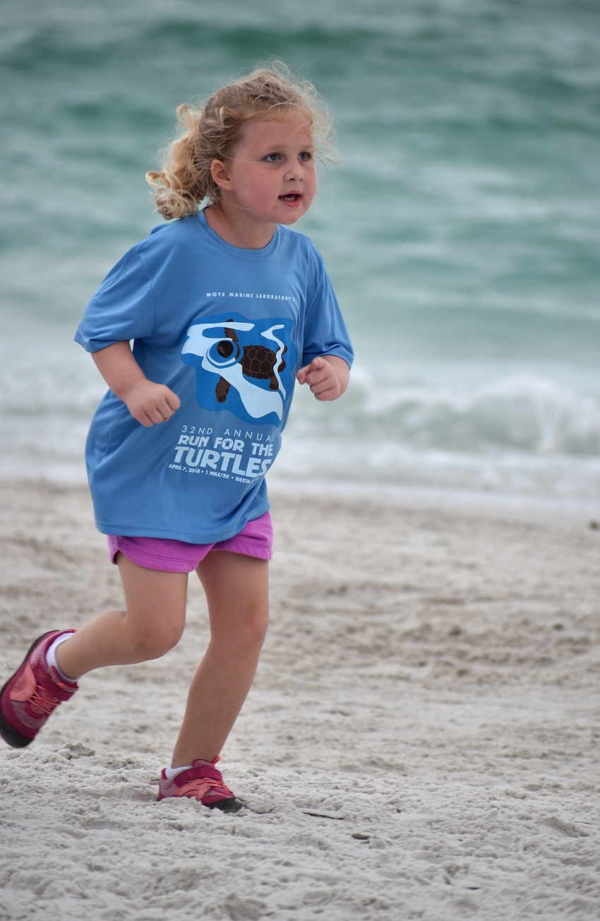 Maicey Dolman finishes the 1-mile fun-run/walk.