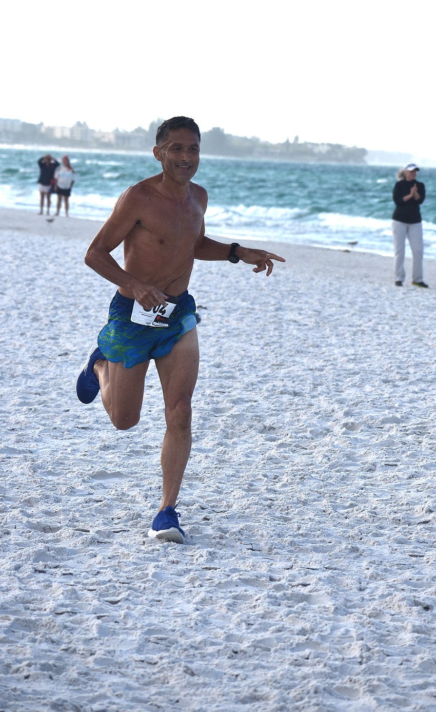 Hector Guzman finishes the 5K in first place.