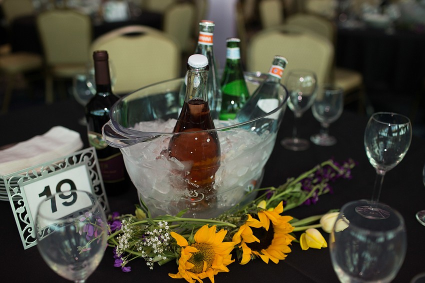Inside, guests sat down for the charity auction with wine at their tables.
