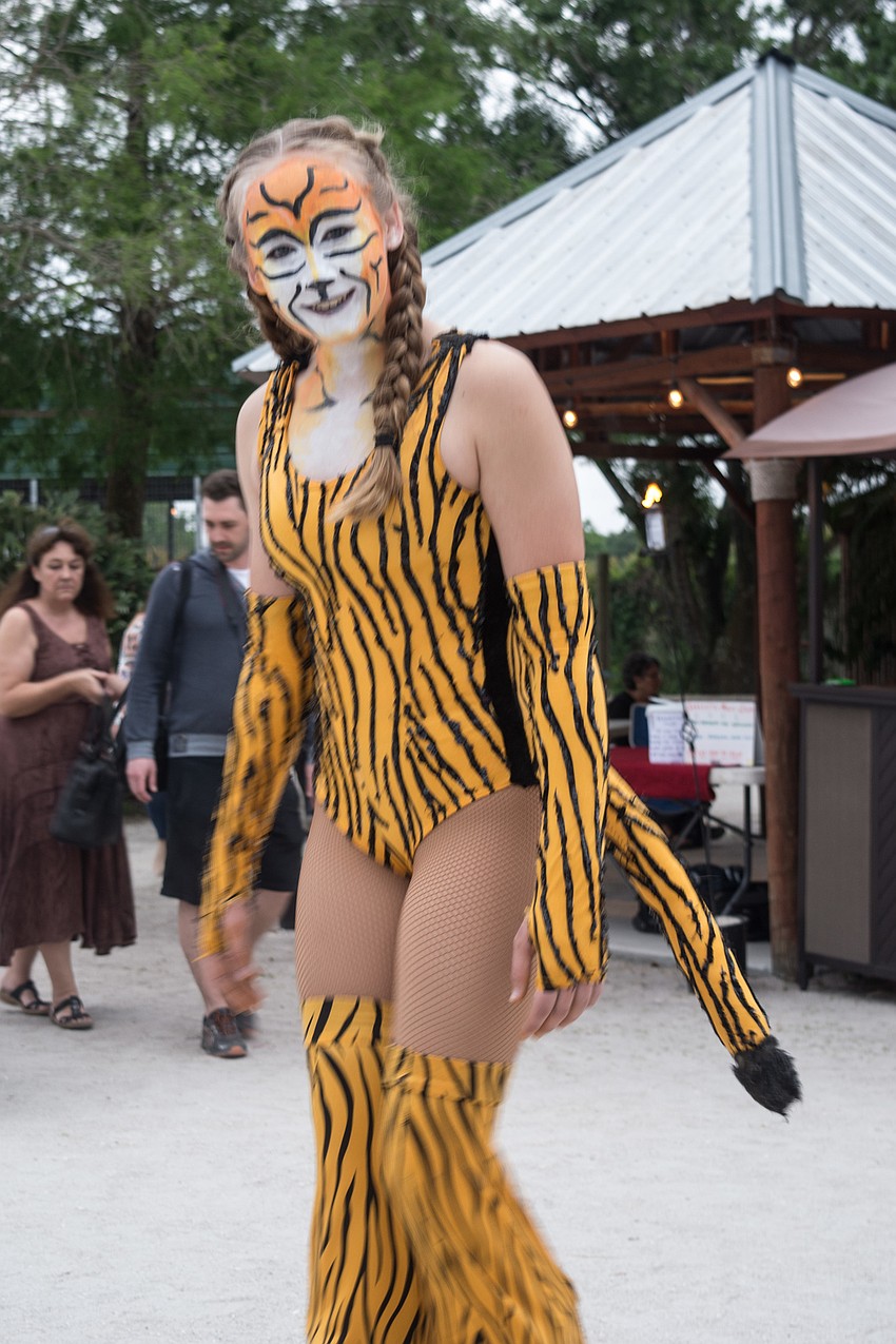 Kaylee Langeneger walks on stilts in a cat costume.