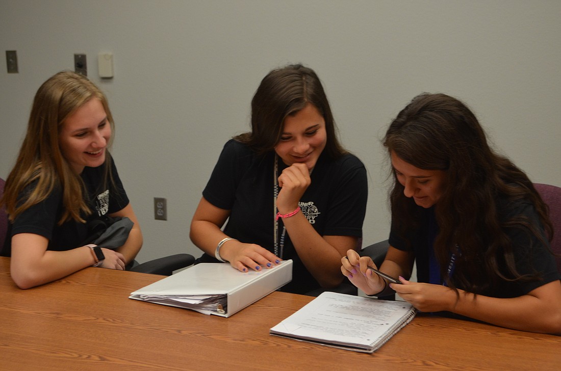 Sarah Farmer, Hannah Arduini and Allison Tibor, all juniors at Braden River, work together to plan the prom at Braden River High School.