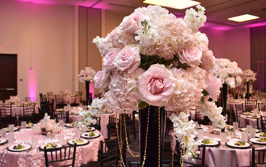 Each table was adorned with a pink and white floral centerpiece.