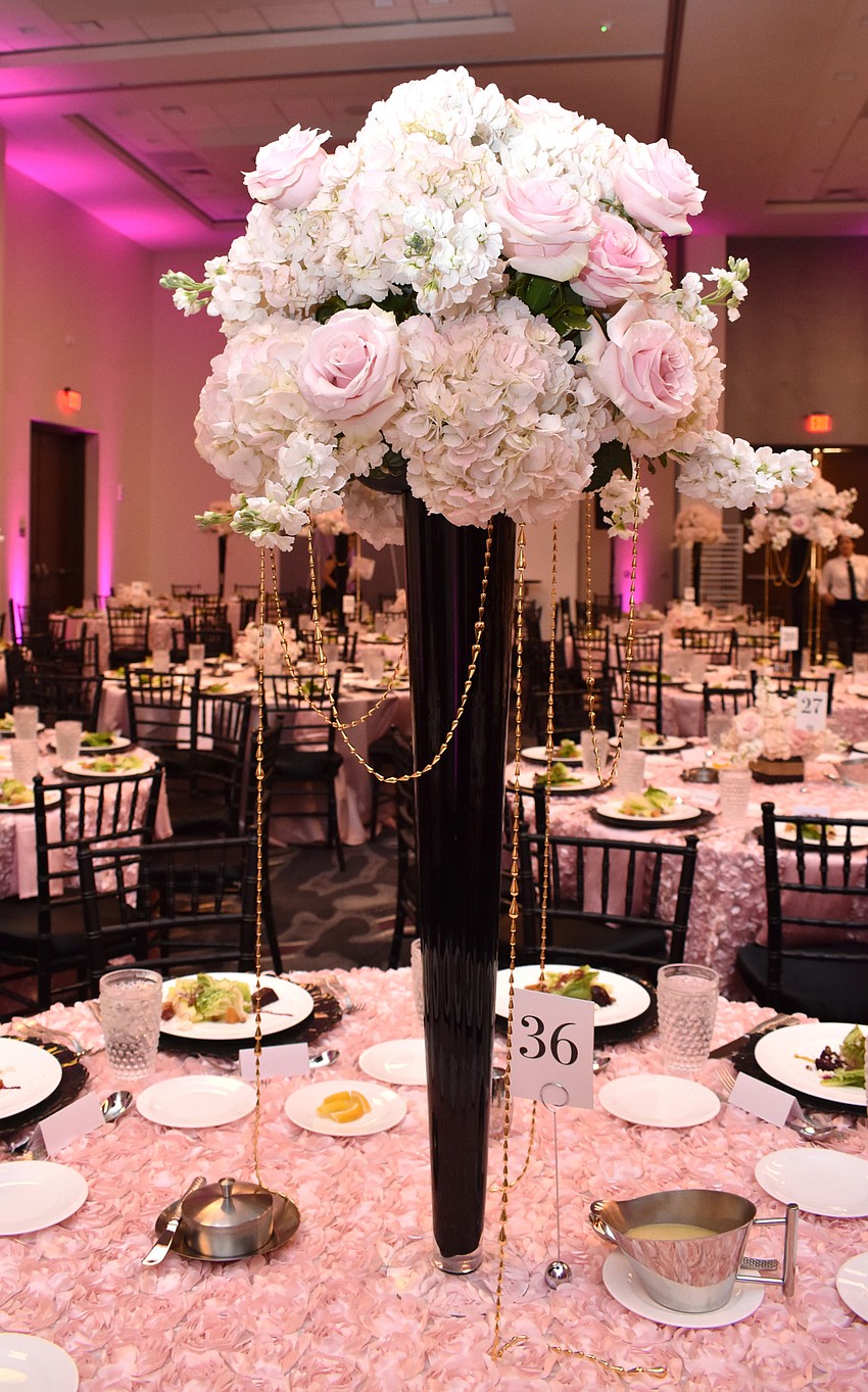 Each table was adorned with a pink and white floral centerpiece.