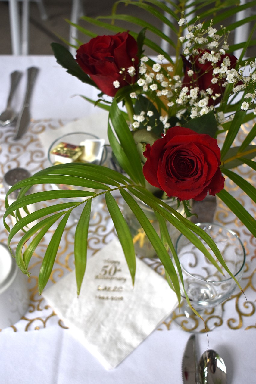 Roses adorned each table with special “50th anniversary” napkins.