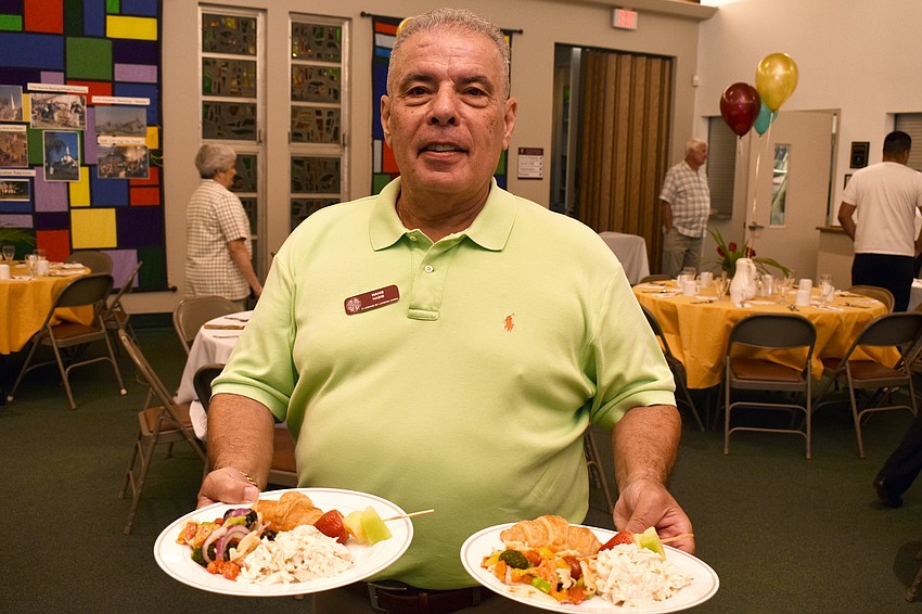 Wahib Habib serves lunch to guests.