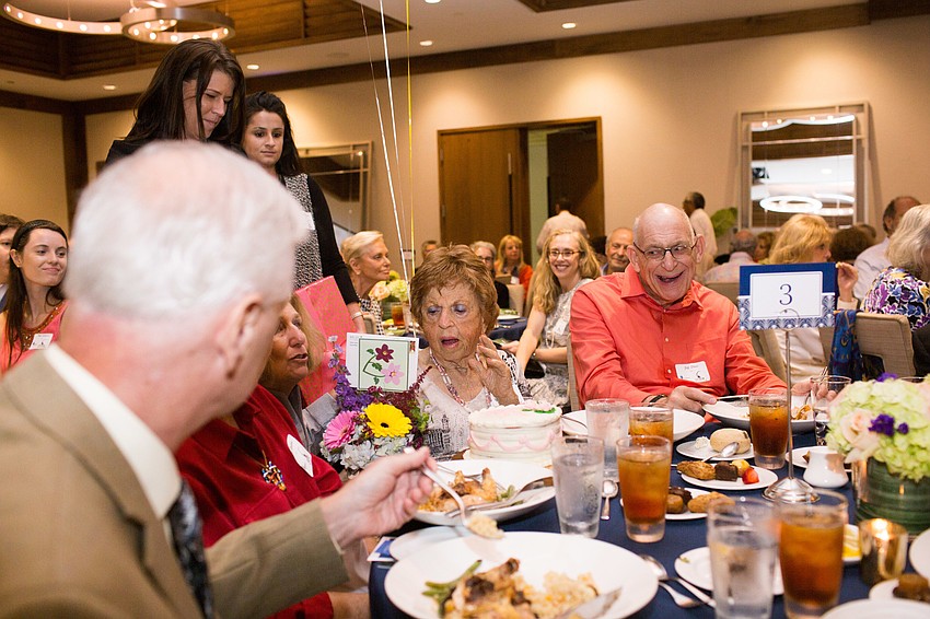 Compeer Sarasota surprised founder Ann Hartka with a present, cake, flowers and balloons for her 100th birthday.
