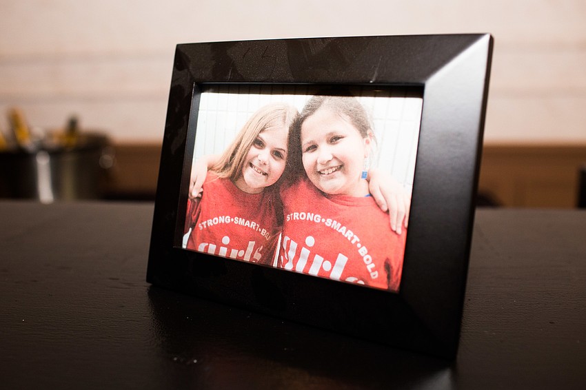 Photos of the Girls Inc. girls were placed around the room.