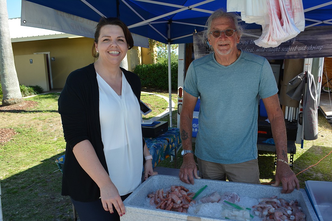 Monaca Onstad, SMR&#39;s director of community relations, visits with Gary Balch, the co-owner of Maggie&#39;s Seafood, at The Market.
