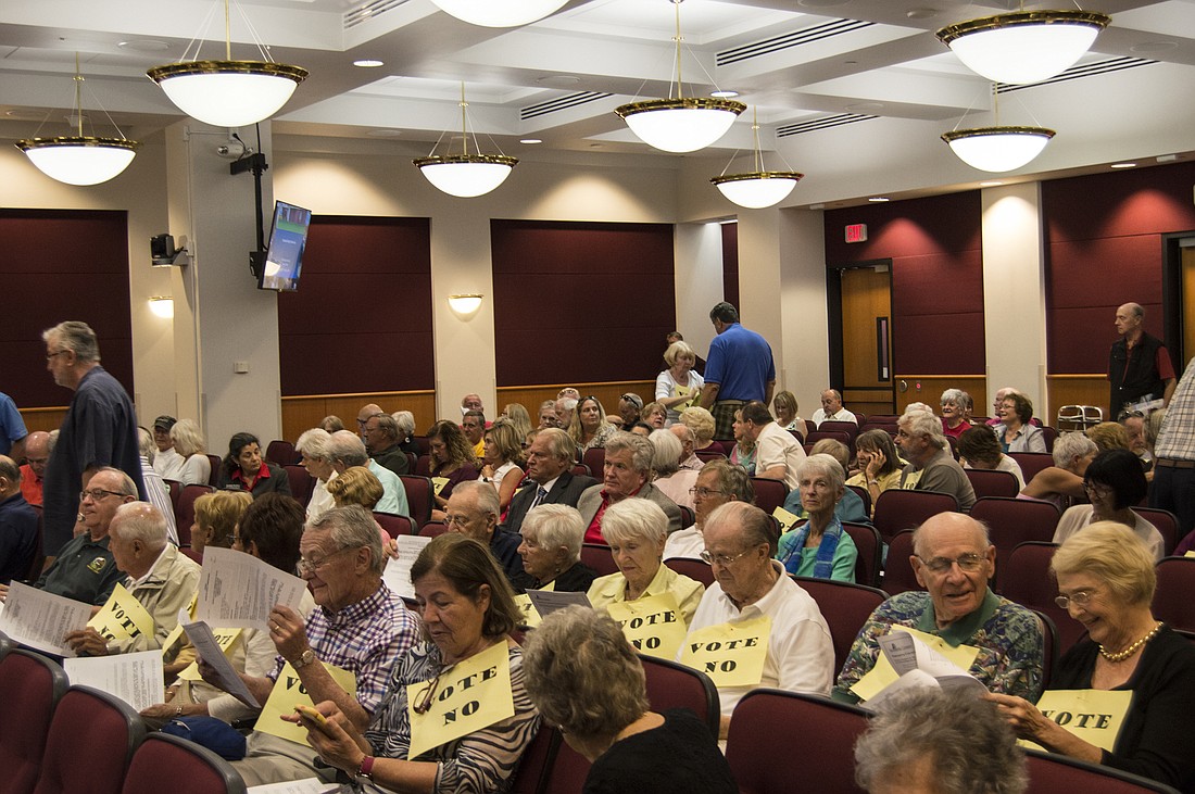 Commission chambers were full of Siesta Key business owners and residents invested in the discussion. Many residents wore signs urging commissioners to "vote no."