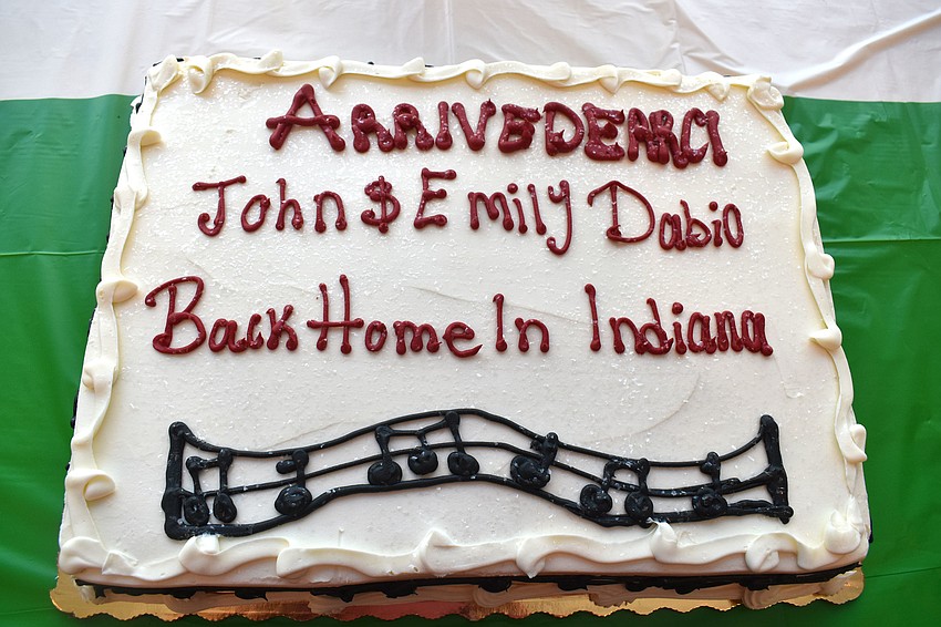 John and Emily Dabio were celebrated with cake at the dinner as they are returning home to Indiana.