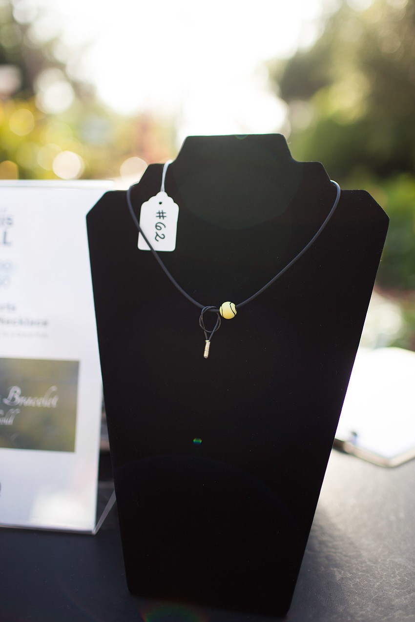 Tennis Ball necklaces were available for purchase as a raffle for a eight Carat diamond tennis bracelet.