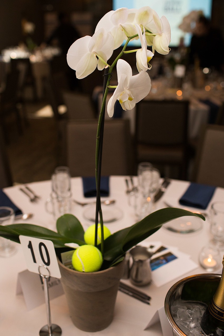 Orchids with tennis balls centered each table.