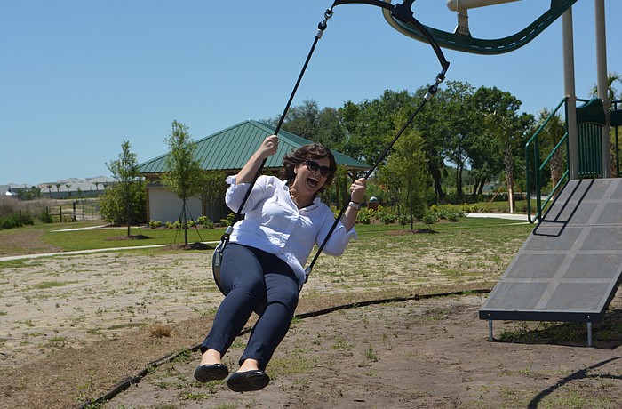 Monaca Onstad, the Schroeder-Manatee Ranch director of community relations, tries out the "Gravity Rail" at Bob Gardner Community Park.
