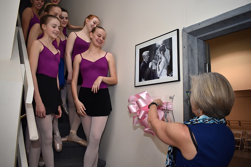 Conservatory members watch President and CEO of the Community Foundation of Sarasota County Roxie Jerde cut the ribbon outside the Ashton Studio.