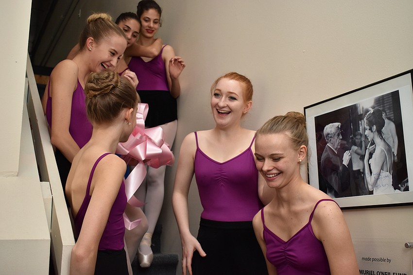 Conservatory members laugh after Jerde gives them the ribbon from the ceremony.