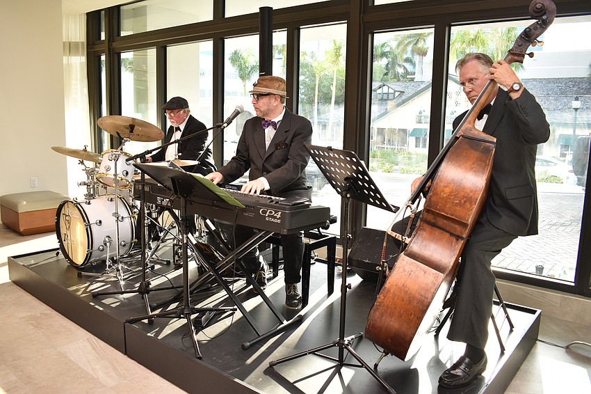 A jazz trio plays for guests in the lobby.