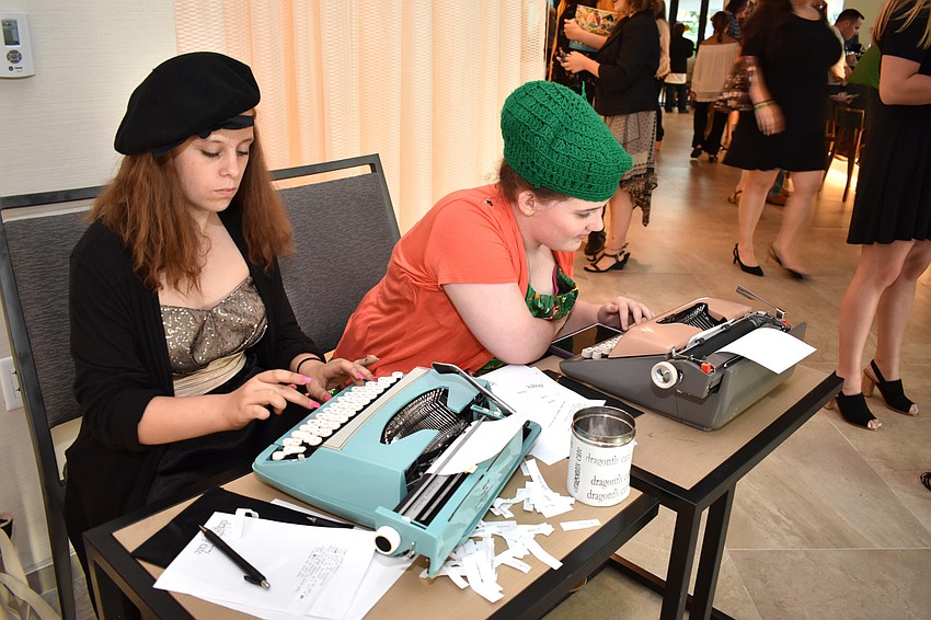 Lindsey Zimmerman, a seventh-grade student at Booker Middle School, and Reese Davis, a sixth-grade student at Booker Middle School, create poems on vintage typewriters after guests pick three words out of a jar for the writers to include.