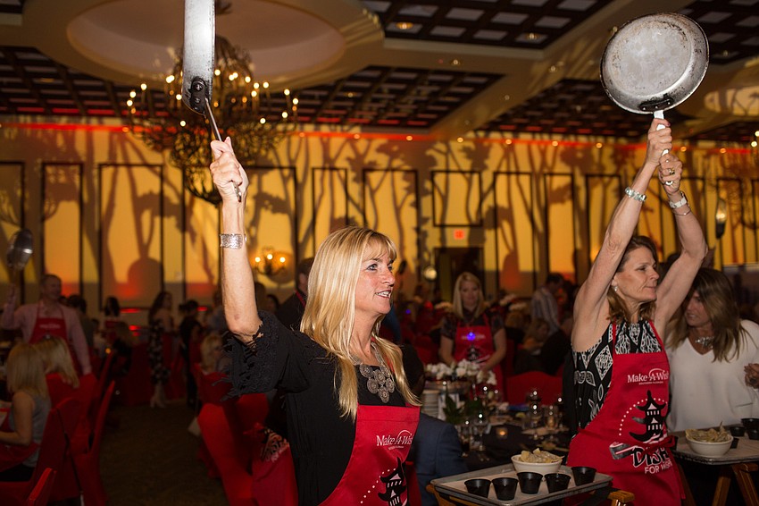 Silke Weiss raises her pan to celebrate the start of dinner.