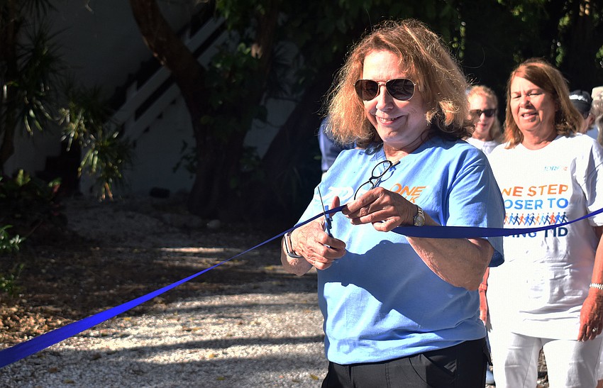 D’Arcy Arpke cuts the ribbon to begin the walk.