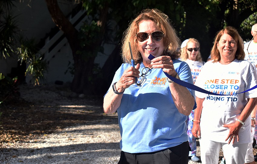 D’Arcy Arpke cuts the ribbon to begin the walk.